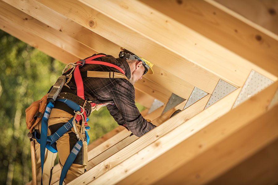 Specialized Business Insurance - View of Contractor Working on Framing New Home